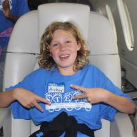 Camper sits in private jet on a field trip for STEPS 2026